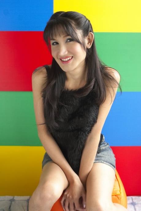 Hot Asian transsexual babe Gisele flaunts her assets in sexy jean skirt