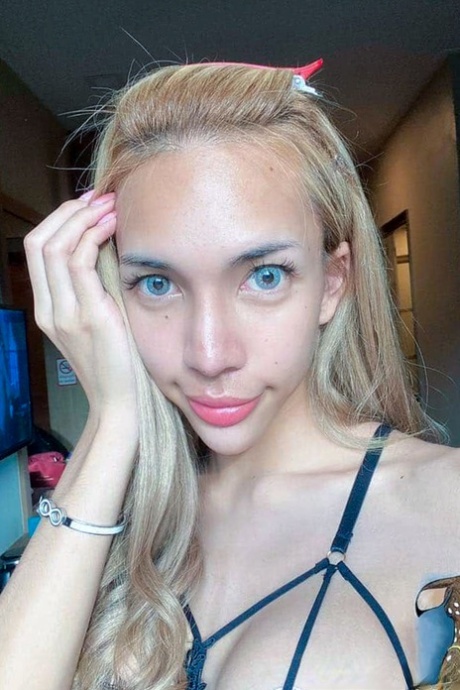 Blue-eyed Asian ladyboy shows off her alluring figure and poses provocatively