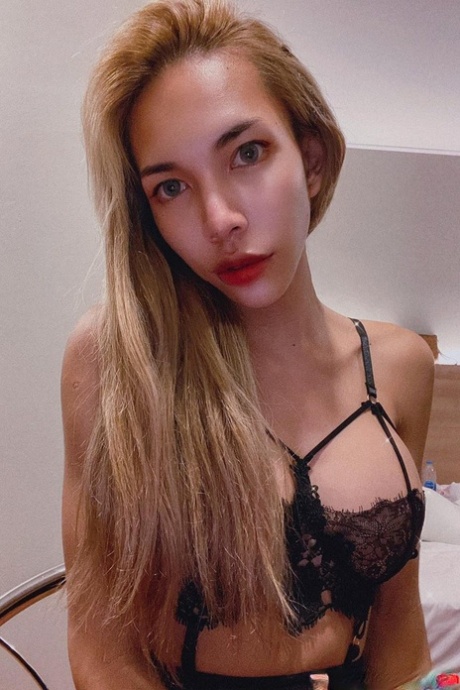 Blue-eyed Asian ladyboy shows off her alluring figure and poses provocatively