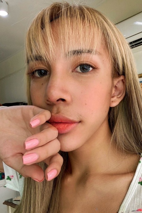 Blue-eyed Asian ladyboy shows off her alluring figure and poses provocatively