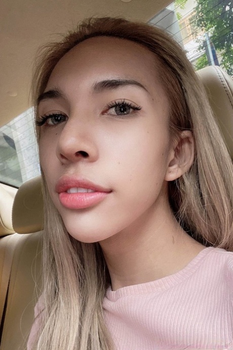 Blue-eyed Asian ladyboy shows off her alluring figure and poses provocatively